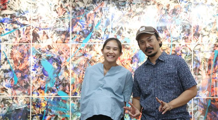 Erika dan Erik dengan latar belakang karya kolaborasi mereka Montage 240 x 360 cm (18 panels), Mix Media in Perspex Sheet, 2017